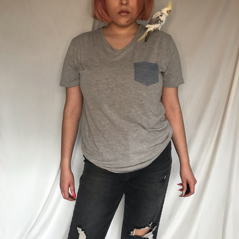 grey shirt with blue pocket